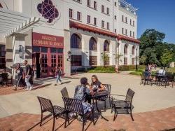 Students sitting outside the Feliciano School of Business enjoying a nice sunny day.